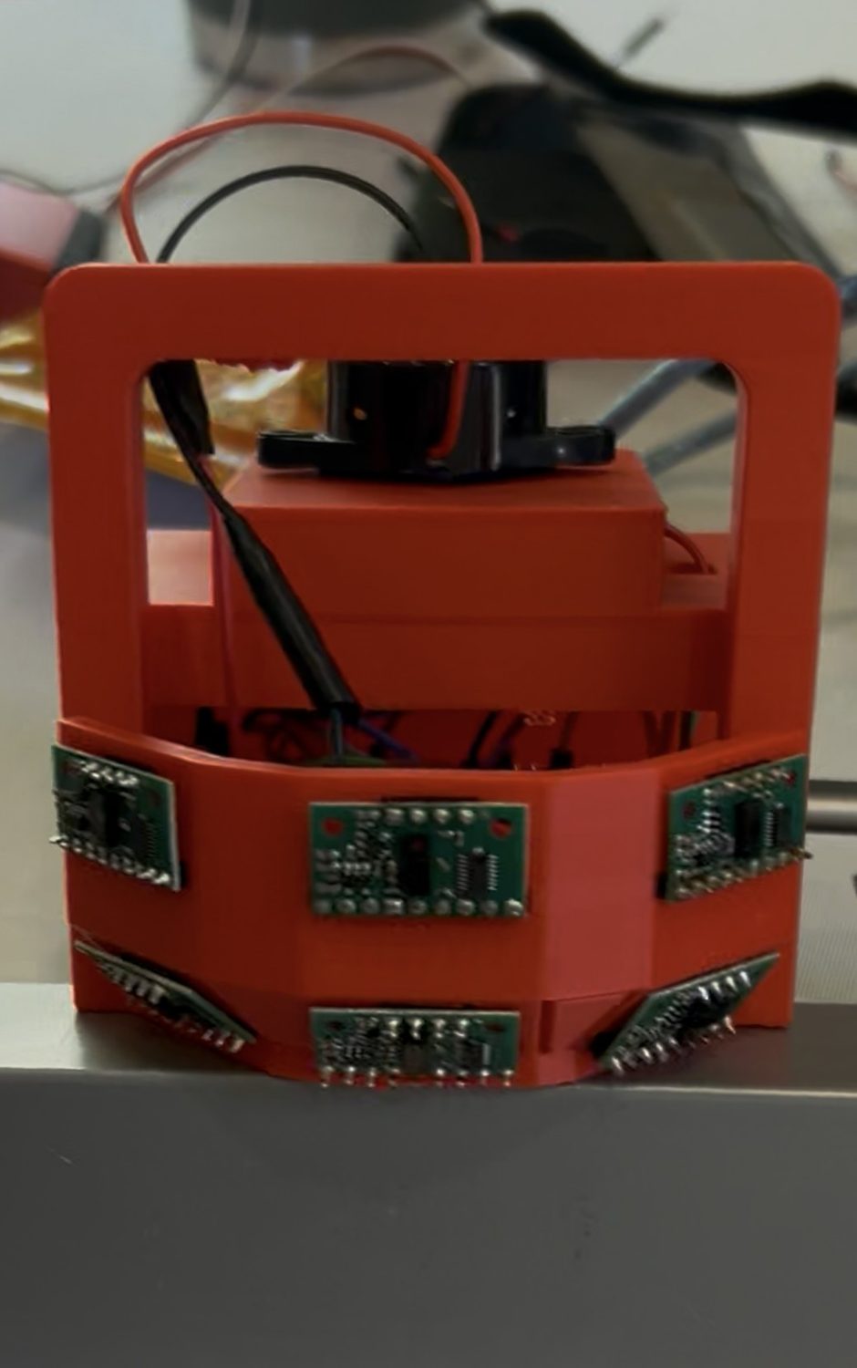 Generation 2 scissor lift sensor module with six time-of-flight sensors on a red 3D-printed mount